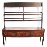 A George III oak dresser, with three tier plate rack above three drawers, on tapered square legs,
