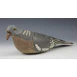A carved and painted pine decoy pigeon, with glass eyes,