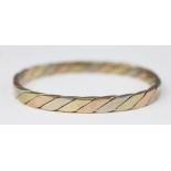 A tri-colour gold bangle, import mark for 1985,