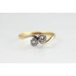 A two stone diamond cross over ring,