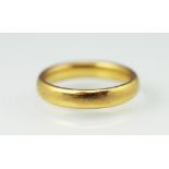 A 22ct yellow gold wedding band,