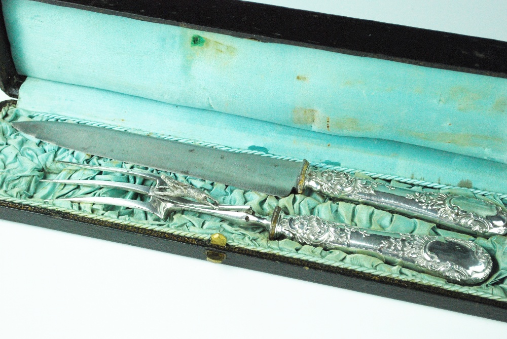 A cased continental 19th century white metal handled carving set, probably French,
