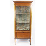 An Edwardian inlaid mahogany slender display cabinet, with astragal glazed door and cupboard below,