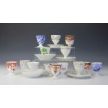 A collection of fourteen 19th century and later egg cups, mostly Derby porcelain,