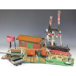 A selection of Hornby and other trail toys, including tin plate station, water towers, wagons etc,
