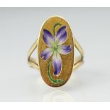 An enamelled 'Violet' ring, designed as an oval panel enamelled with a violet flower,