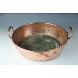 A large copper preserve pan, the circular pan mounted with two handles,
