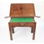 A George III mahogany architects desk / table, the adjustable ratchet top with a moulded edge,