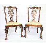 Three Chippendale style dining chairs, with pierced splats, on cabriole legs and claw and ball feet,
