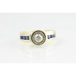 A diamond and sapphire set ring, designed as a central diamond, collet set,