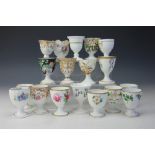A collection eighteen 19th century and later egg cups, all floral examples,