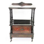 A Victorian ebonised and amboyna two tier Canterbury, on turned legs,