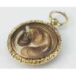A Victorian mourning locket, with central hair panel, florally cast border,