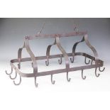A wrought iron country kitchen hanging saucepan rack, with sixteen hooks,