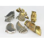 Six vesta cases, to include; a pewter pig 6cm long, a brass seated pig holding a money bag,