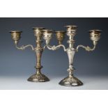 A pair of silver candelabra, W I Broadway & Co, Birmingham 1978, each embossed with floral sprays,