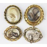 A collection of four Victorian mourning or memorial brooches,