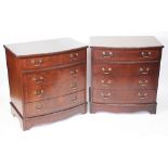 A pair of reproduction mahogany bow front chest of drawers, with four graduated long drawers,