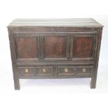 An early 18th century oak mule chest, with hinged top, triple panelled front and two drawers,