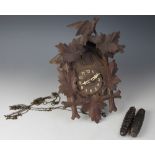 A 19th century Black forest cuckoo clock, with moulded leaf decoration and surmount,