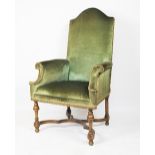 A late 17th century style walnut arm chair, early 20th century, with green upholstery,