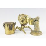 A brass mounted novelty vesta and striker in the form of Lucifer, the brass mask upon a hollow nut,