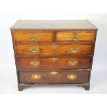 A George III oak chest, with two short and three graduated long drawers, on bracket feet,