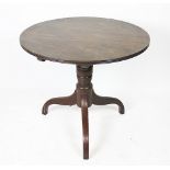 An early 19th century mahogany tilt top occasional table, with circular top,