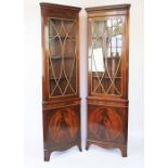 A pair of reproduction mahogany corner cabinets, with astragal glazed doors and cupboard doors,