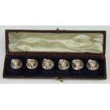 A set of six white metal buttons,