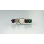 An ADORE ring, set with an amethyst, diamond, opal ruby and emerald,