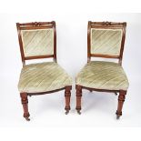 A set of six Victorian walnut dining chairs, with upholstered backs and seats,