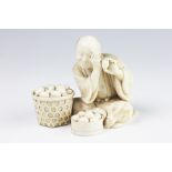 A Japanese Tokyo School carved ivory large okimono of an egg seller / tester, Meiji period,