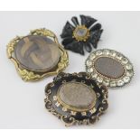 A Georgian paste set oval brooch, the central panel inset with woven hair,