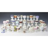 A large collection of 19th century and later porcelain egg cups,
