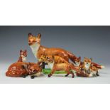 A collection of assorted fox ornaments, to include; a Beswick fox 13cm high,