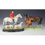A Beswick hunting group of a huntsman seated upon a dapple grey horse with two hounds besides,
