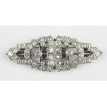 An Art Deco diamond set duet brooch, circa 1925, of typical stepped, architectural form,