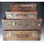 Four vintage tan leather and canvas suit cases,