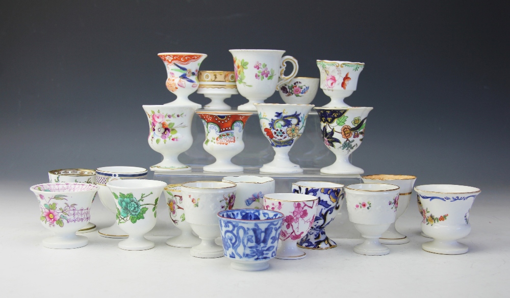 A collection of twenty three 19th century and later egg cups, mostly Coalport,