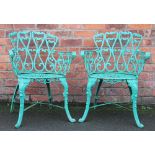 A set of four cast iron garden tub chairs, with foliate detailing,