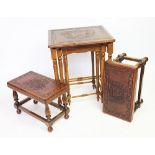 A Peruvian carved hardwood triple nest of tables, with leather mounted tops embossed with a mask,