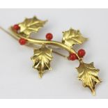 An 18ct yellow gold and coral coloured bead set brooch,