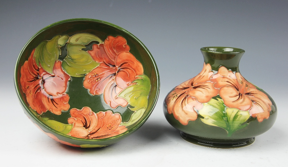 A Moorcroft Hibiscus pattern vase, of squat ovoid form, peach blooms against a green ground, 9.