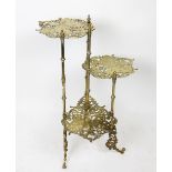 A cast brass three tier jardiniere stand, decorated with butterflies,