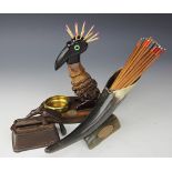 A novelty cast iron table match dispenser, designed as a bird with spiked beak on slotted base,