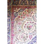 A Persian Tabriz wool carpet, worked with a scrolling foliate design against an ivory ground,