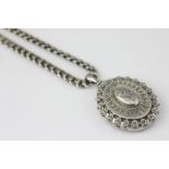 A Victorian silver locket and chain, Birmingham 1886,