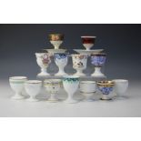 A collection of thirteen Worcester egg cups,