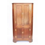 A late Victorian walnut corner cabinet, with four doors, on bracket feet,